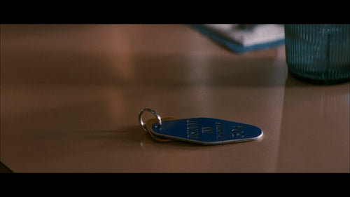 Memento Discount Inn Enamel Keychain